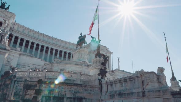 Italian Flag Waving Against the Equestrian Statue Representing the Italian King Vittorio Emanuele II