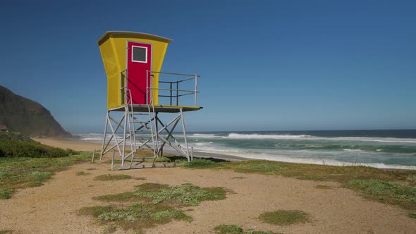 Colourful lifeguard tower overlooking secluded beach