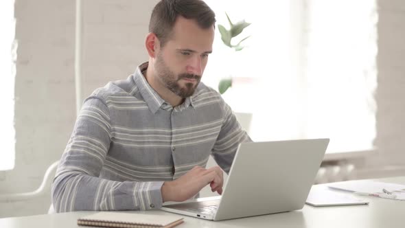 Adult Young Man Working on Laptop