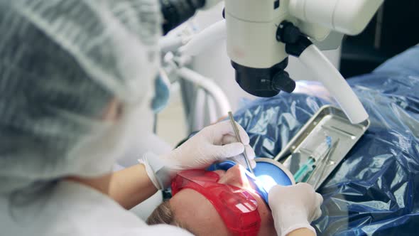 Patient is Getting Her Teeth Treated By Dentists