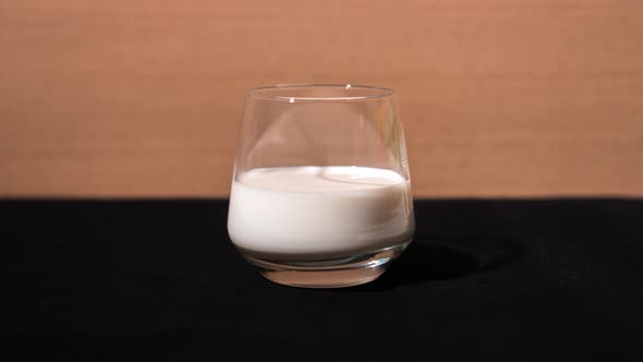 Milk Is Poured Into the Glass Cup