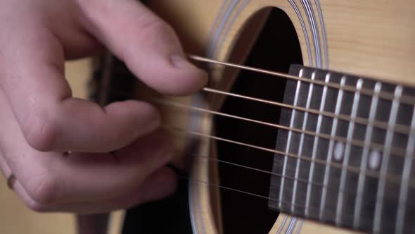 Man Playing Guitar, Focus on Strings, Close Up