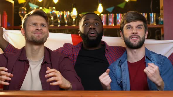 Multiracial Sports Fans Waving English Flag in Bar Displeased About Match Losing