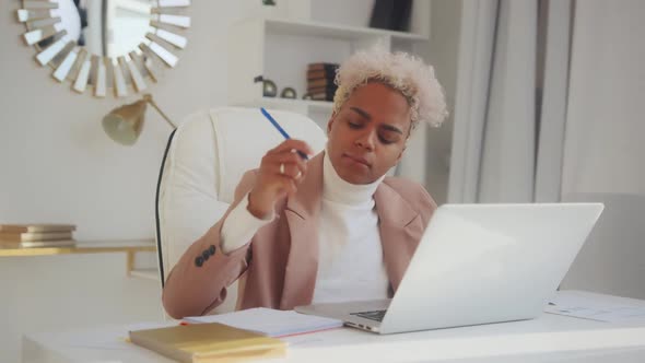 Young African American Woman Works in Large Corporation Sits in Office