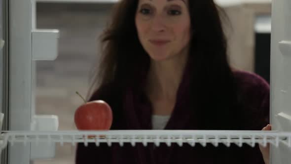 Woman Taking Apple From Fridge