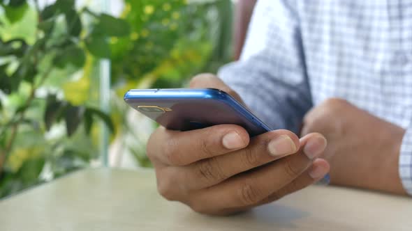 Close Up of Young Man Hand Using Smart Phone