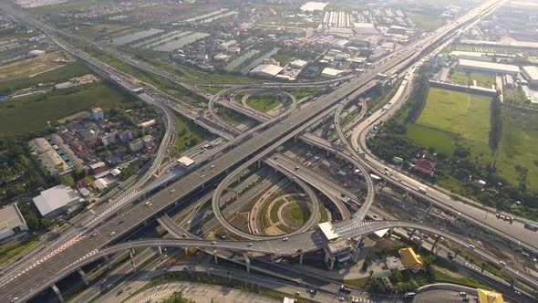 Aerial View of Highway Road Interchange with Busy Urban Traffic Speeding on Road