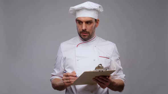 Male Chef with Clipboard and Pen Writing