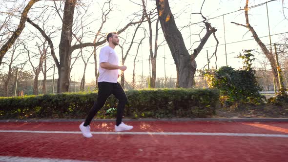 The athlete is running in the park.