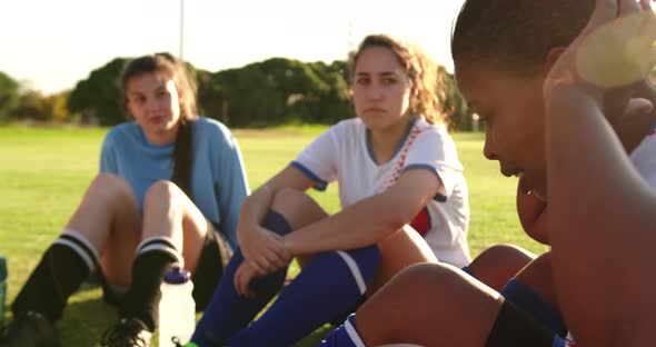 Female soccer team in break time talking on soccer field. 4k