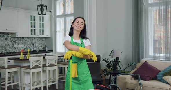 Woman-Worker of Cleaning Company in Uniform Posing on Camera During Cleaning