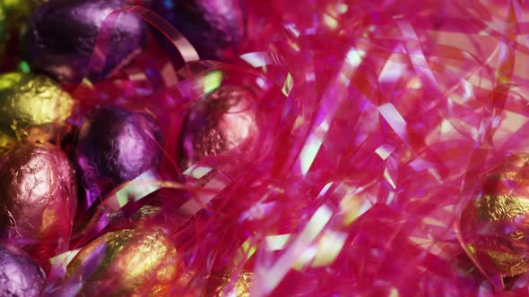 Rotating shot of colorful Easter candies on a bed of easter grass