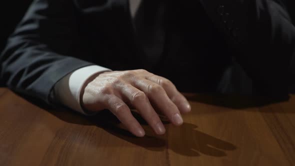 Frustrated Mafia Boss Drumming Fingers on Table, Thinking or Making Decision