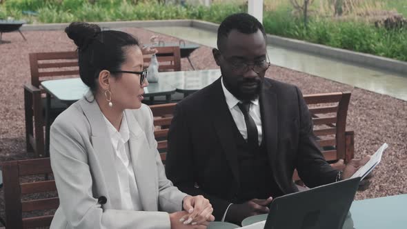 Businesspeople Working in Outdoor Cafe