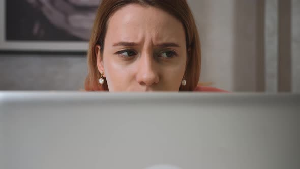 Close Up Worried Sad Businesswoman Face Looking at Laptop at the Home Office