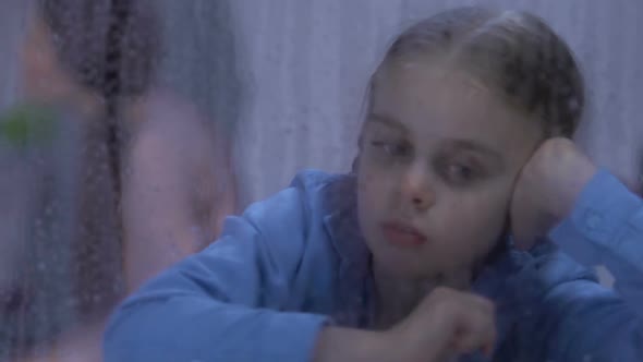 Daughter Looking in Rainy Window, Parents Quarreling on Background, Conflict