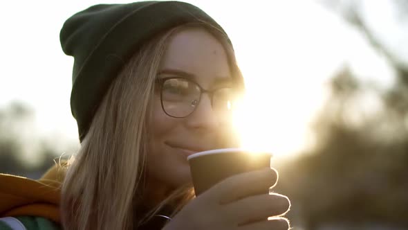 Portrait of a Woman Drinking a Hot Drink Steam From Hot Coffee or Tea Len Flares