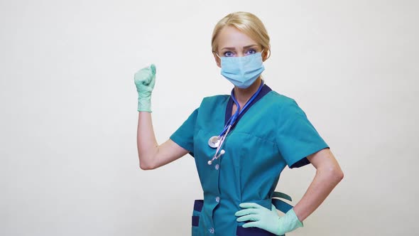 Medical Doctor Nurse Woman Wearing Protective Mask and Rubber or Latex Gloves - Yes Win Gesture