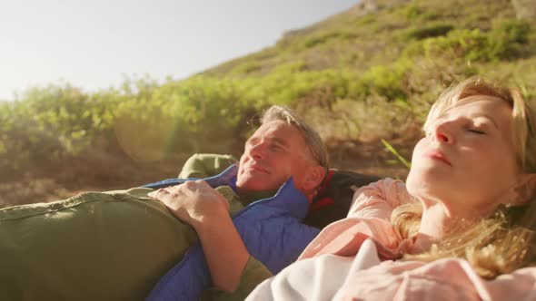 Active senior couple elongate in forest