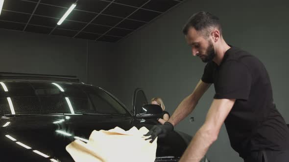 Man and Woman Clean the Car