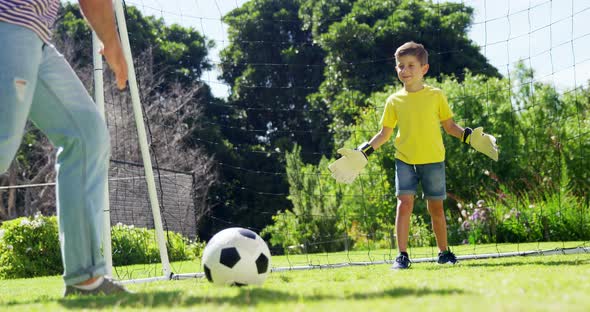 Father and son playing football