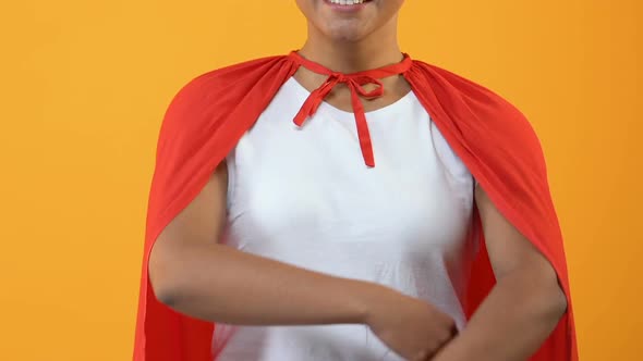 Smiling Young Lady in Red Cape on Bright Background, Powerful Wonder Woman