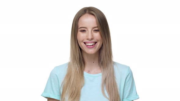 Portrait of Caucasian Woman 20s Wearing Basic Tshirt Nodding and Meaning Agreement Isolated Over