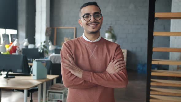 Cheerful Middle Eastern Businessman Crossing Arms and Smiling Looking at Camera