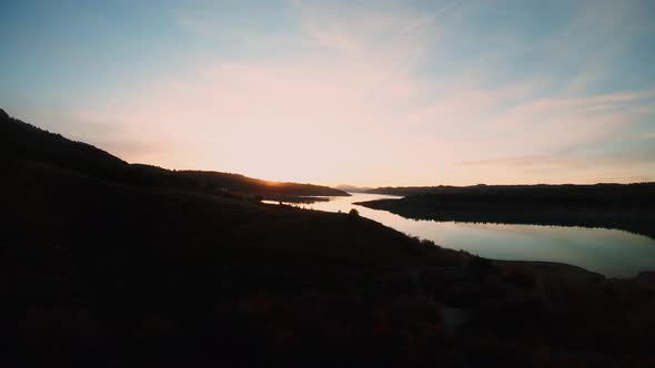 Aerial Shot of Dusk or Dawn on River Shore