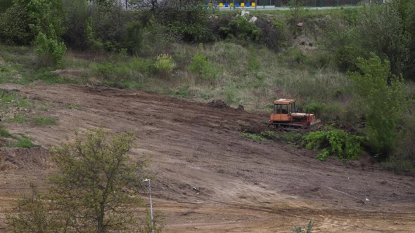 Timelapse: bulldozer flattening surface on further construction site