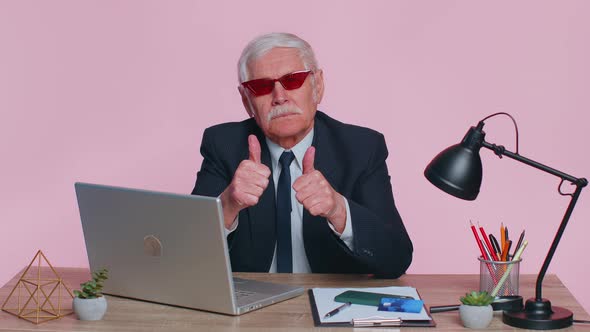 Senior Business Man Raises Thumbs Up Agrees Approve Likes Good News Using Laptop at Pink Office