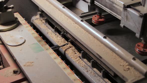 Process of drilling holes in a furniture board