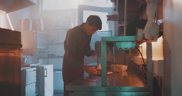 A professional chef is plating in the kitchen