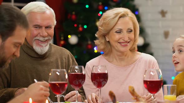 Cute Girl Telling Funny Story to Adults at Holiday Dinner, Family Celebration