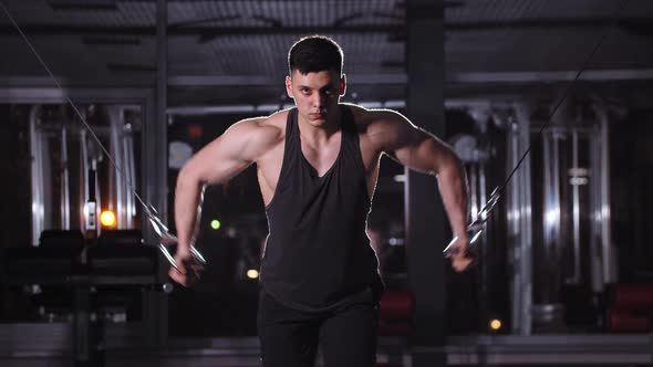 Handsome Young Man Training His Hands in the Gym