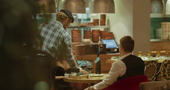 Waiter Carries in Two Hands Plates of Food Hot Dishes