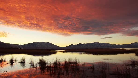 Colorful sunrise on Utah Lake as the water ripples