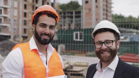 Portrait of the Happy Builder and Businessman Looking at the Camera Standing on the Construction