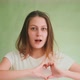 Lovely Woman Shows Heart with Fingers Posing at Green Wall - VideoHive Item for Sale