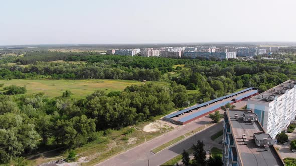 Aerial View of Multi-Storey Buildings at Sleeping Area of Small City Near Forest