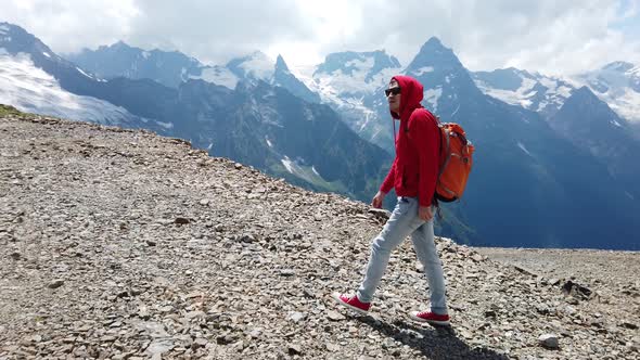 Adult Male in Red Hoodie with Hood Enjoying Beautiful View in Mountainous Area