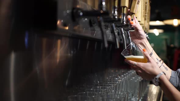 Hands of a girl serving beer in a bar in Patagonia Argentina