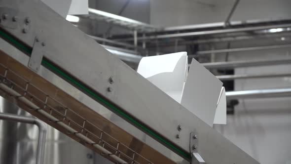 Movement of Conveyor Belt with Two White Cardboard Boxes on It