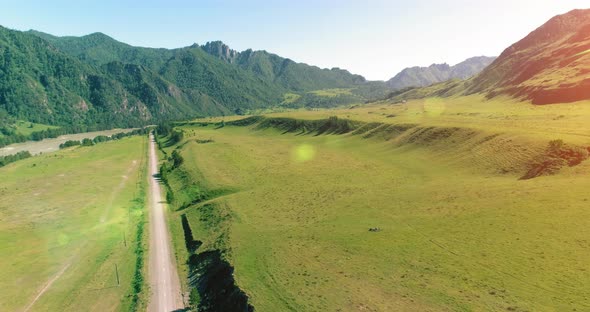 Aerial Rural Mountain Road and Meadow at Sunny Summer Morning