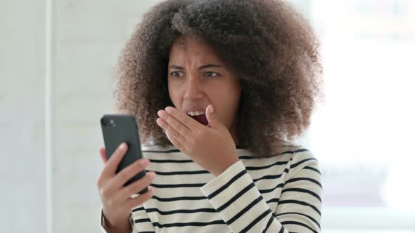 African Woman Having Loss on Smartphone 