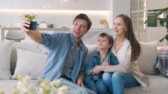 Family Takes Selfie on the Sofa