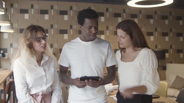 Team of Colleagues Watching Content on Tablet