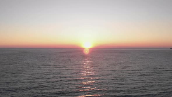 Water surface at sunset. Beautiful sea sundown in summer. Sunlight reflecting on waves