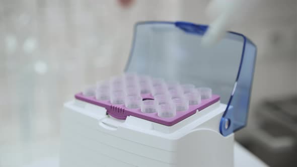 Scientist Collects the Sample Using Automatic Pipette alt