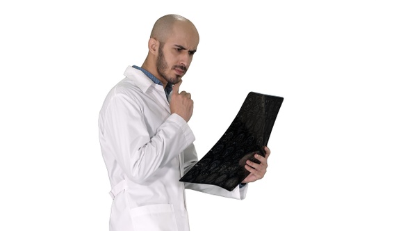 Young male physician reading and reviewing a MRI brain